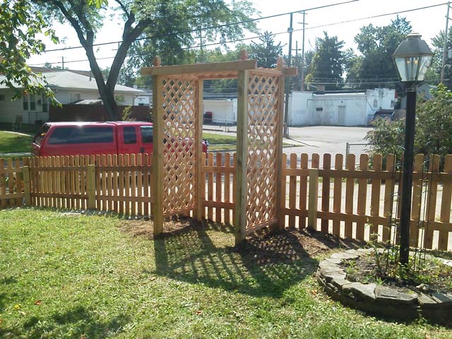 Cedar picket fence with decorative wood trellis